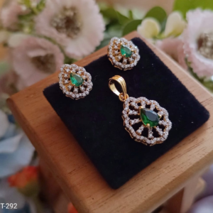 Gold plated emerald green stone pendant and earrings jewellery set with sparkling CZ diamond detailing by Trinket Trails for women party and festive wear