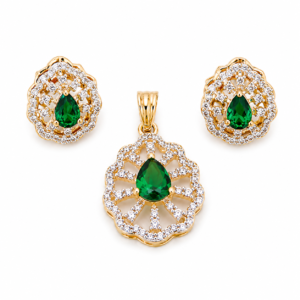Elegant emerald green stone pendant set with matching earrings and sparkling American diamonds in gold plated designer jewellery style by Trinket Trails